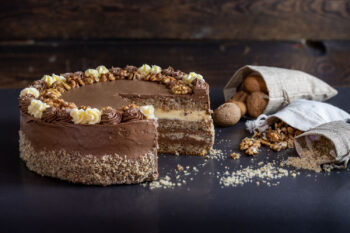 Nut cake Jacek Placek confectionery is synonymous with the taste of homemade cakes made of natural products. Nut sponge cake, chocolate cream, lemon cream, halva, and walnuts. 